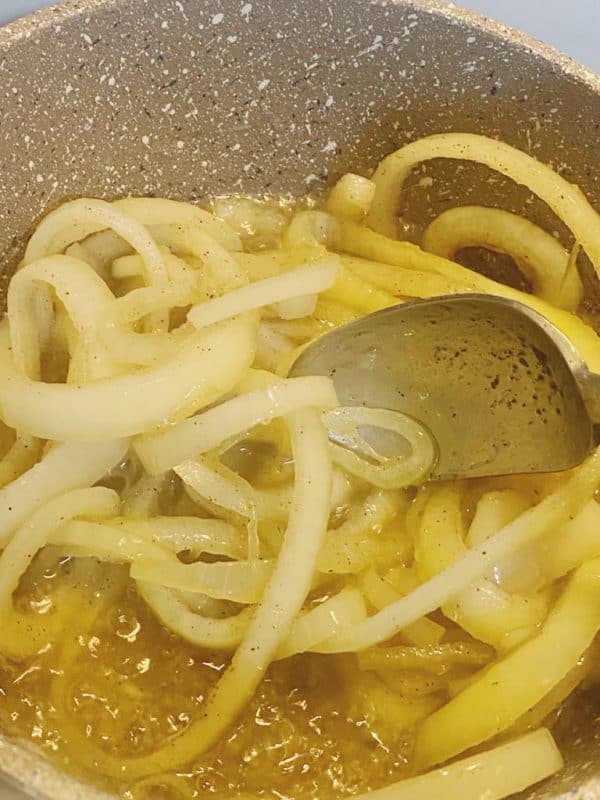 Onions caramelizing in oil in a pan