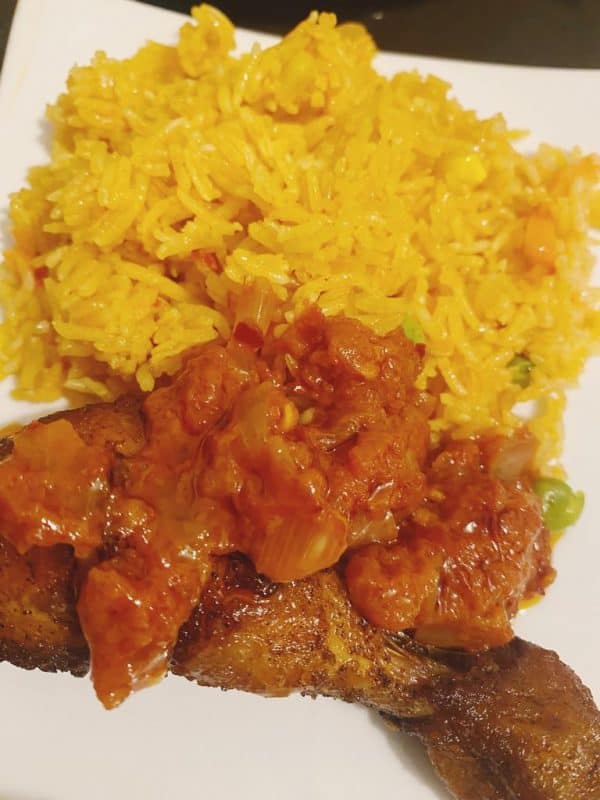 Tomato-infused rice served with golden fried chicken topped with tomato gravy