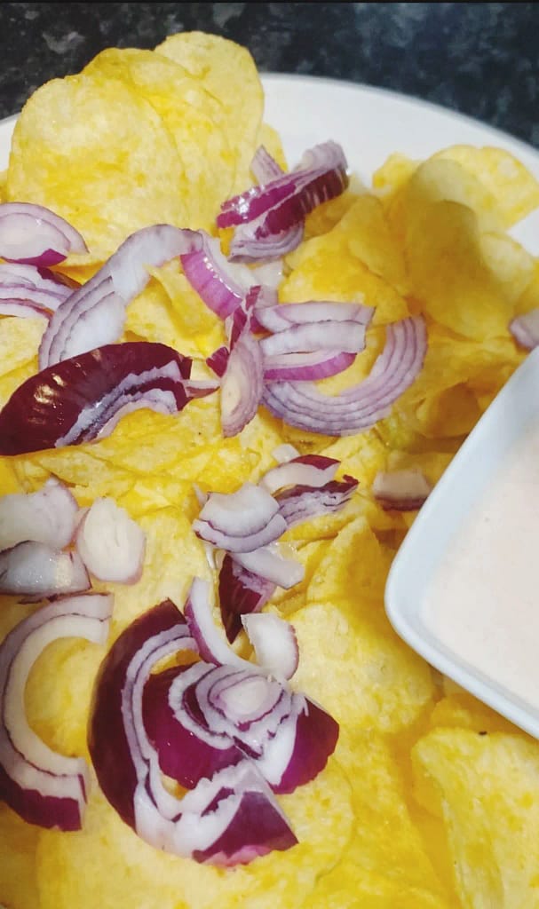 Cheese and onion chips spread on a plate