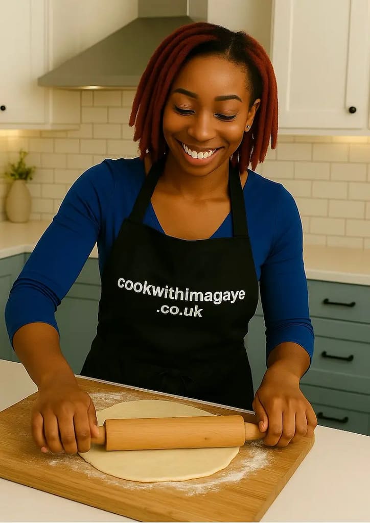 Woman rolling out dough on a floured board with a wooden rolling pin.