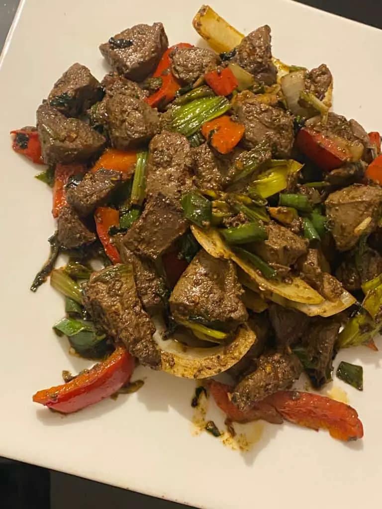Seared liver pieces are combined with sautéed onions, bell peppers, and leeks in a skillet for the Gourmet Blend recipe.