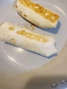 Shawarma rolls gently toasting in a skillet until golden brown.