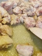 Chicken wings frying in oil until golden brown